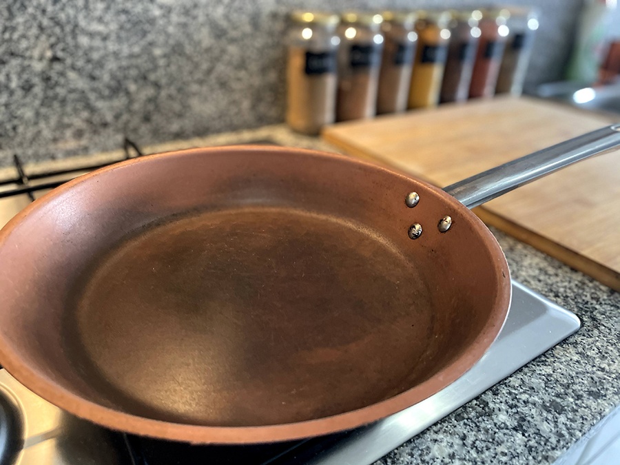 A copper pan that has discoloured from use