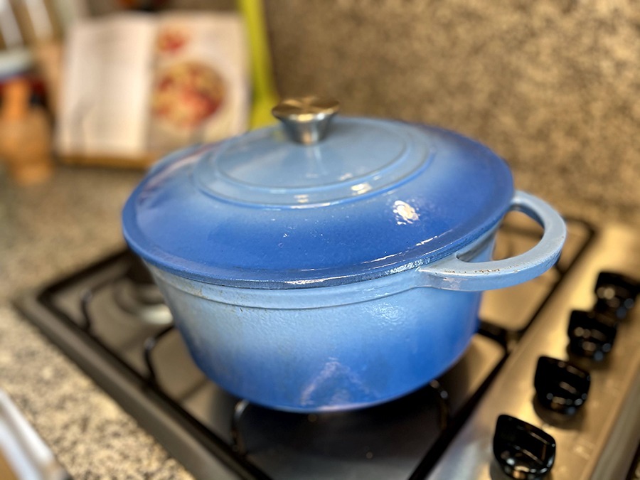 A blue french oven casserole dish with the lid on