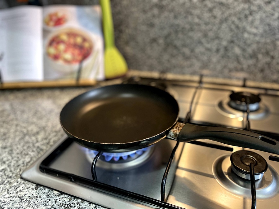 an old non-stick frying pan on a gas hob